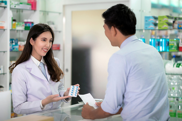 Pharmacist helping a customer.