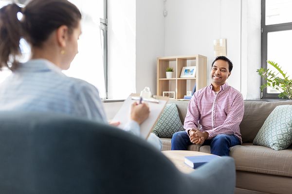 man on couch meeting with doctor