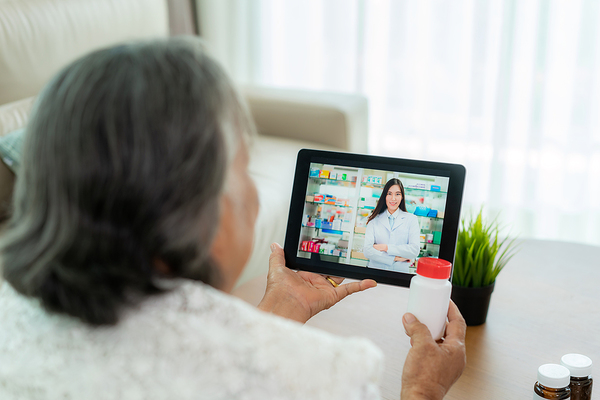 older woman talking to doctor on tablet
