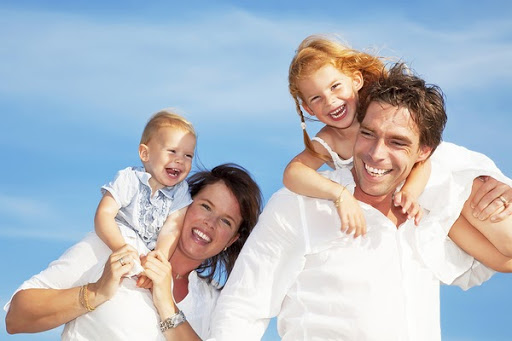 family with kids on shoulders