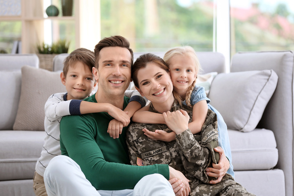 family lying in a row smiling at camera