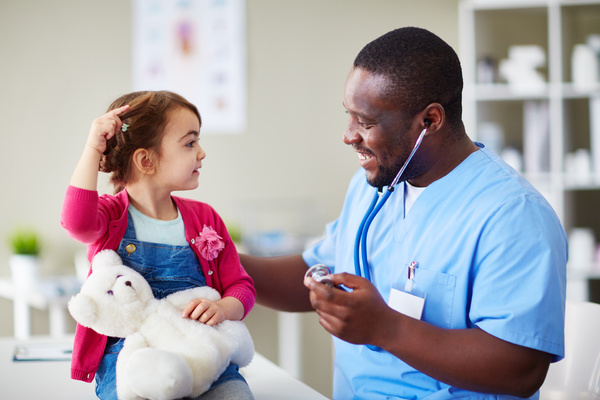 Doctor smiling with young patient