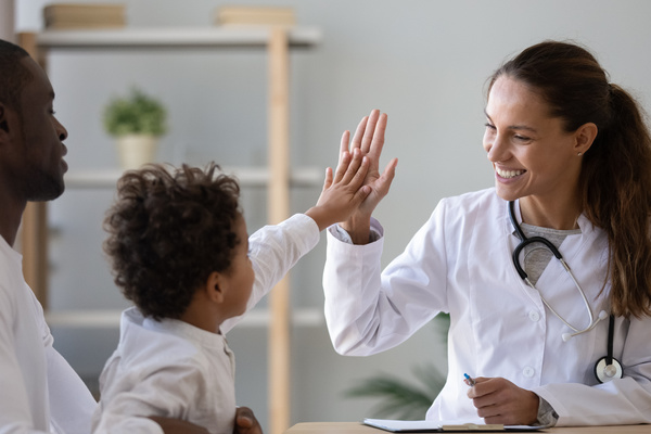 octor and young child doing a high five