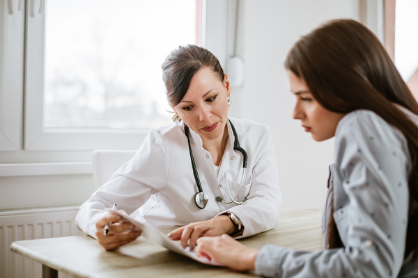 Doctor and female patient reviewing paperwork