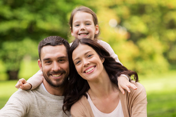 Couple with young daughter smiling